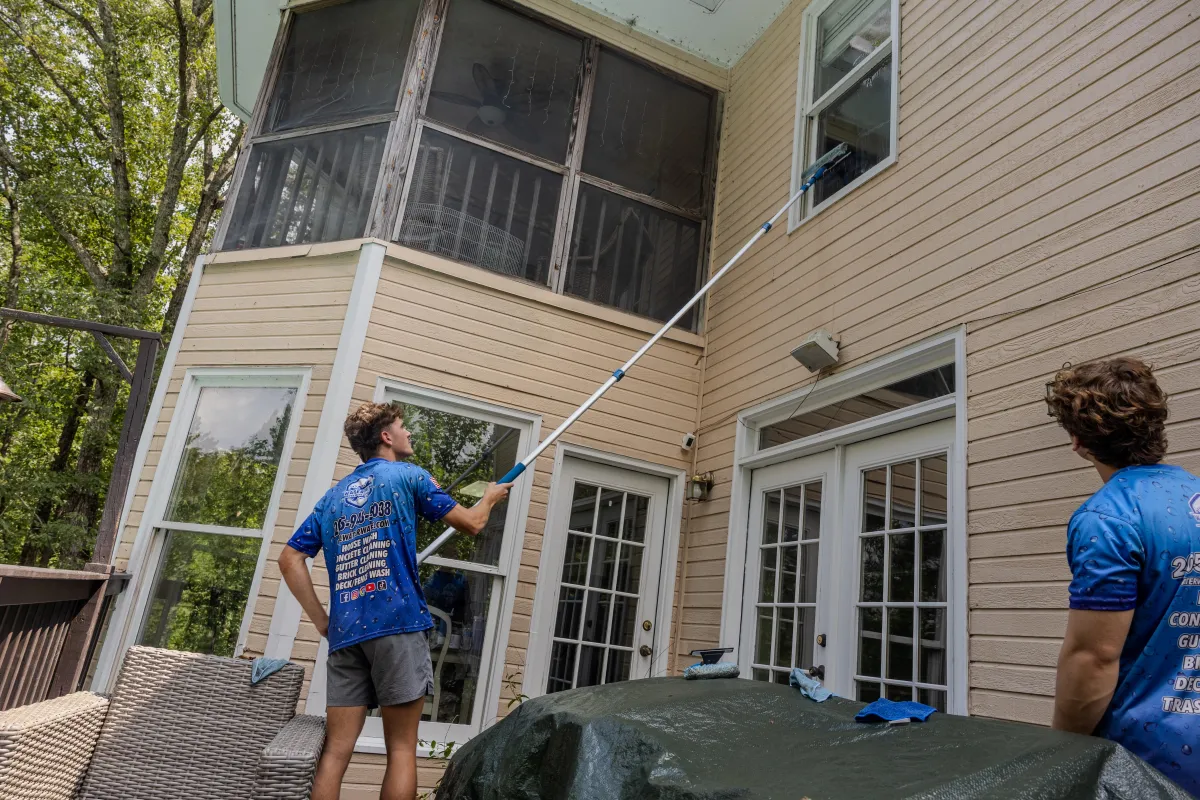 Washing a two-story house with an extension pole